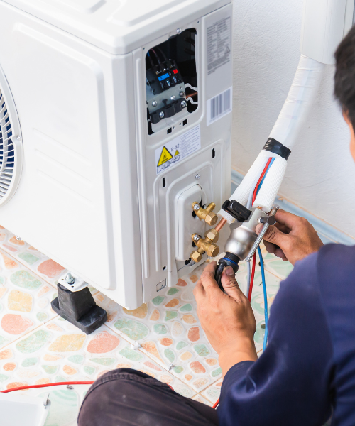 A man working on an air conditioner