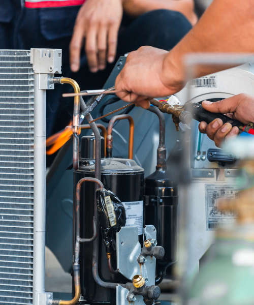 A man working on an air conditioner