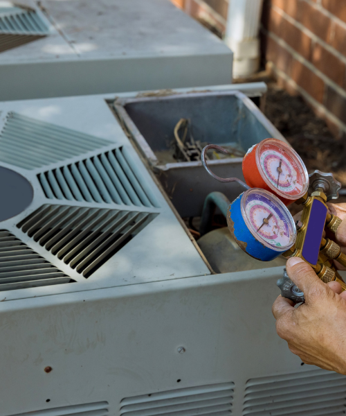 A man is checking the temperature of a furnace