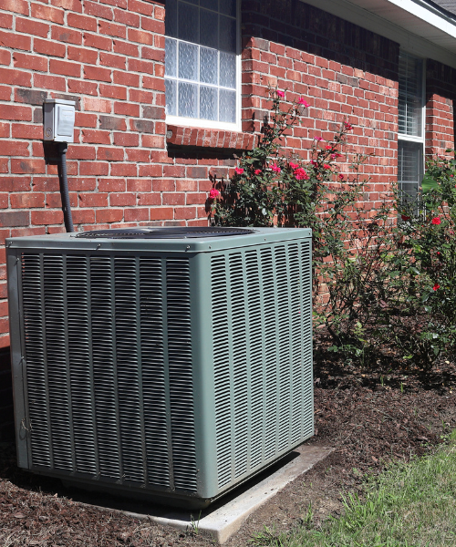 An air conditioner outside of a brick building