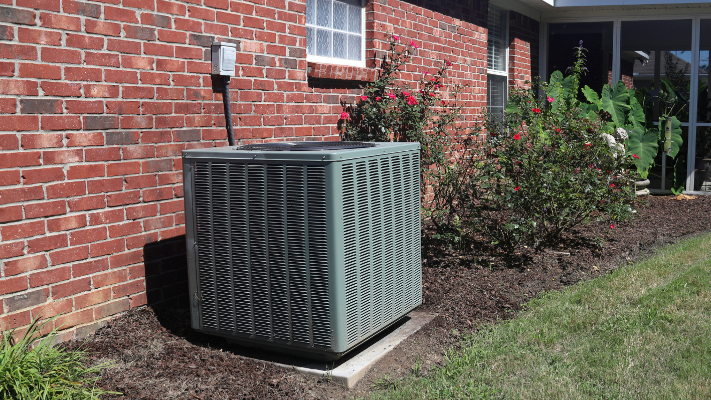 An air conditioner outside of a brick building