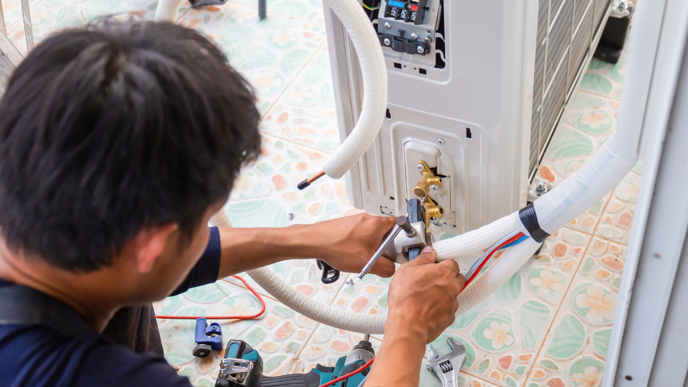 A man working on an air conditioner